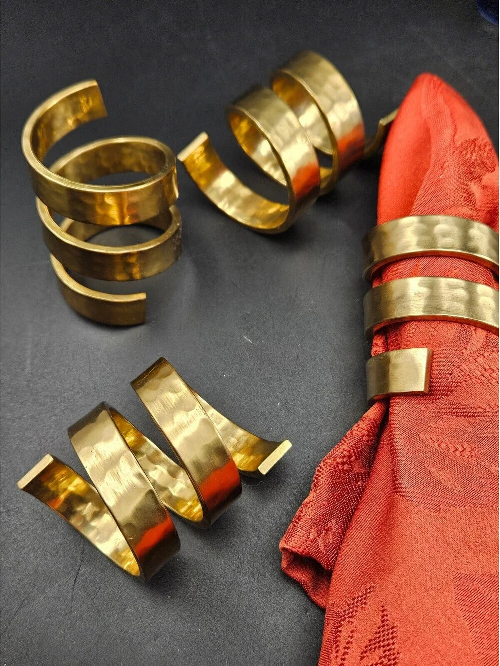 Set of 4 Spiral Hammered Brass Napkin Rings and 4 Red Napkins
